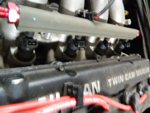 1995 Honda Civic - Close-up of engine fuel injectors and part of the valve cover with text.