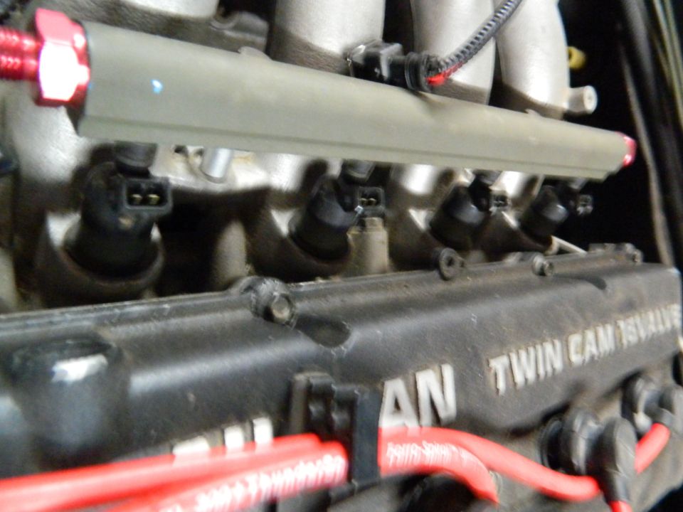 Engine fuel rail with injectors, TWIN CAM 16VALVE text visible on valve cover