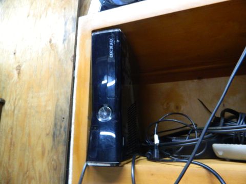 1995 Honda Civic - An Xbox 360 console is visible on a shelf, next to a collection of wires.