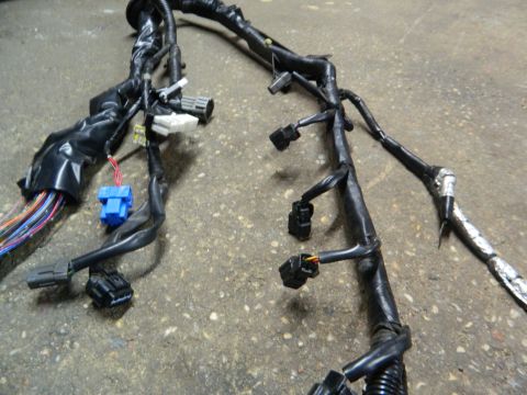 1995 Honda Civic - A complex automotive wiring harness is laid out on a textured concrete floor, showing various connectors and wires.