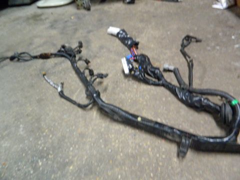 1995 Honda Civic - A vehicle wiring harness lies on a concrete surface, showing its complex network of wires and connectors.