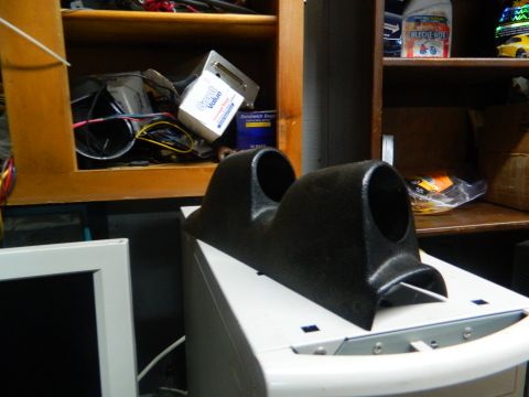 1995 Honda Civic - A black dual gauge pod sits on a white object, with shelves filled with various items behind it.