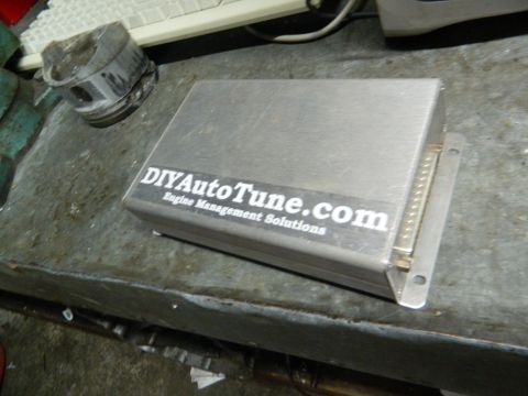 1995 Honda Civic - An engine control unit with a sticker for DIYAutoTune.com is shown next to a piston.