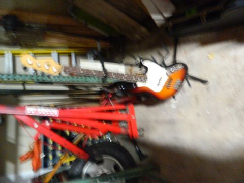 1995 Honda Civic - An electric guitar with an orange and white body is visible in this scene, along with some red equipment and a tire.