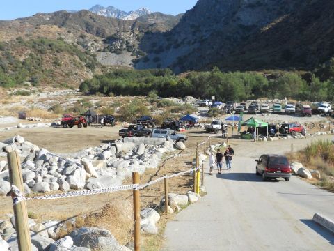 1986 Ford Bronco - A gathering of off-road vehicles and spectators in a scenic, mountainous terrain.