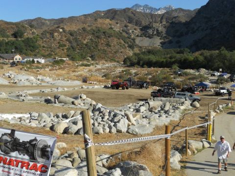 1986 Ford Bronco - A scene of off-road vehicles in a , mountainous terrain, possibly at an event or gathering.