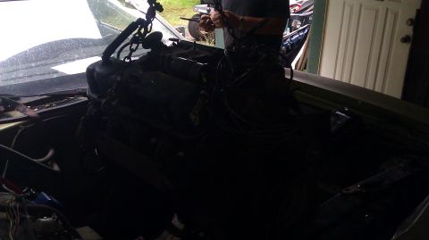 1973 Ford Torino - Engine removal in progress, with chains suspending the motor from above.