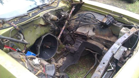 1973 Ford Torino - Disassembled 1973 Ford Torino engine bay, transmission housing visible.