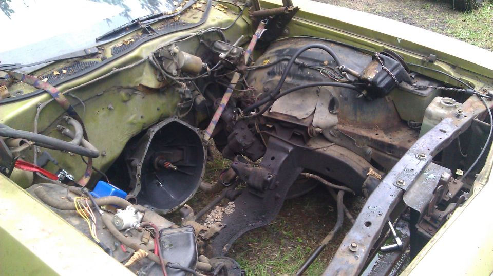 1973 Ford Torino engine bay with transmission removed, showing engine block and frame components