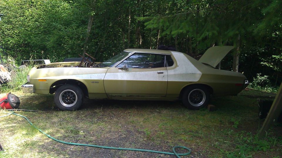 1973 Ford Torino coupe with hood and trunk open, parked outdoors