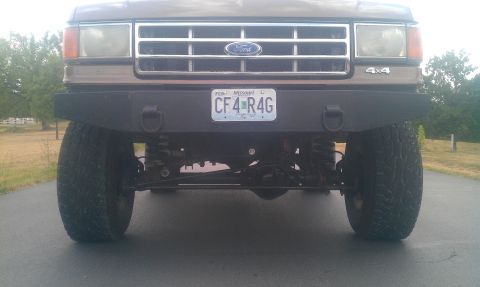1987 Ford Bronco - Front view of a 1987 Ford Bronco, showing its grille, headlights, and custom bumper.