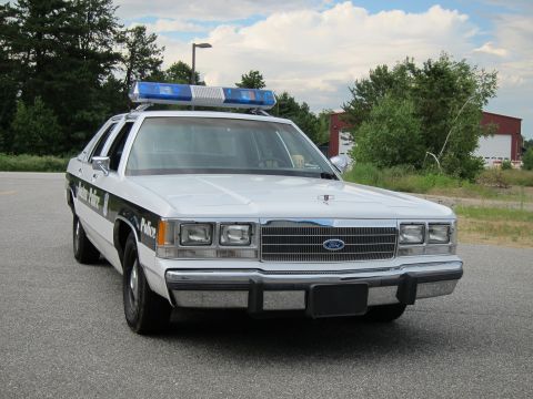 1991 Ford LTD Crown Victoria - White 1991 Ford Crown Victoria LTD police car with light bar on roof.