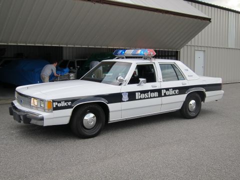 1991 Ford LTD Crown Victoria - This 1991 Ford Crown Victoria LTD police car, marked "Boston Police," is parked outside a large building.