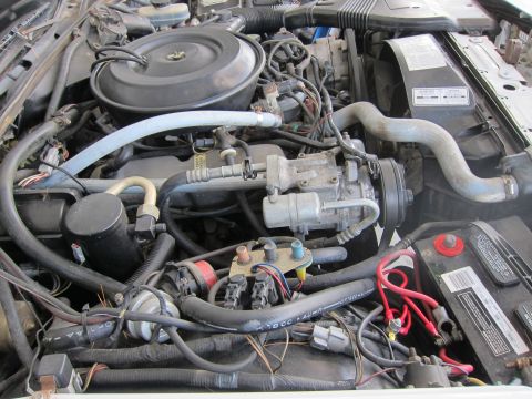 1991 Ford LTD Crown Victoria - Close-up view of a car's engine bay, showing various mechanical parts and wiring.