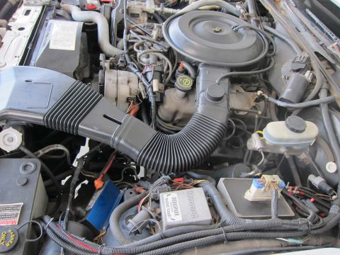 1991 Ford LTD Crown Victoria - Close-up of a car's engine bay, showing various components and wiring.