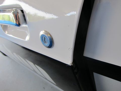 1991 Ford LTD Crown Victoria - Close-up of a car door's lock cylinder and handle assembly.