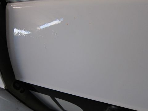 1991 Ford LTD Crown Victoria - Close-up view of a white car door, showing some minor paint chips and blemishes.