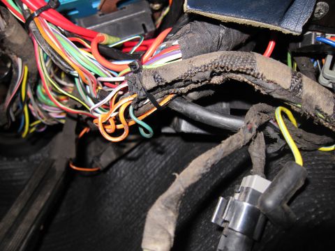 1991 Ford LTD Crown Victoria - Close-up of a complex vehicle wiring harness, showing numerous colored wires and connectors.