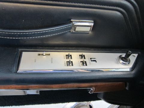 1991 Ford LTD Crown Victoria - Close-up of a car's interior door panel, showing the power window and lock controls.