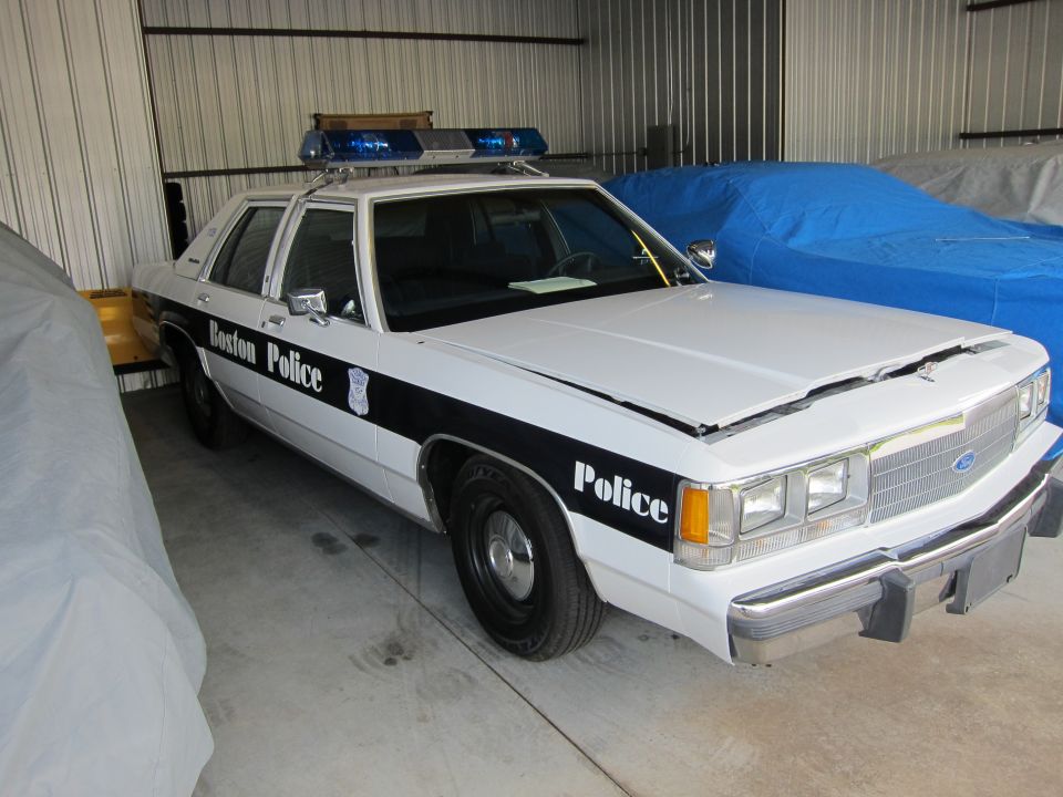 White police car with 'Boston Police' on the side and a light bar on top