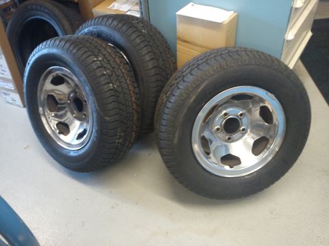 1997 Chevrolet Silverado 1500 - Set of four chrome wheels and tires, likely aftermarket replacements.