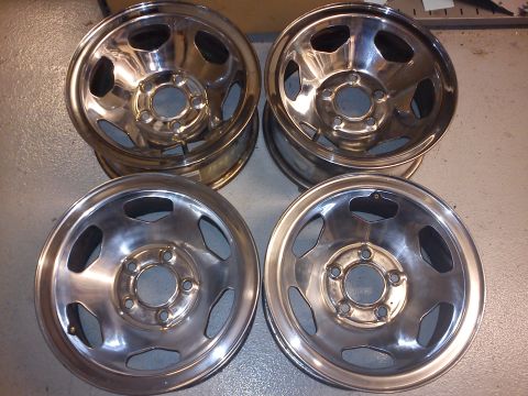 1997 Chevrolet Silverado 1500 - Set of four chrome wheels, likely aftermarket, shown indoors.