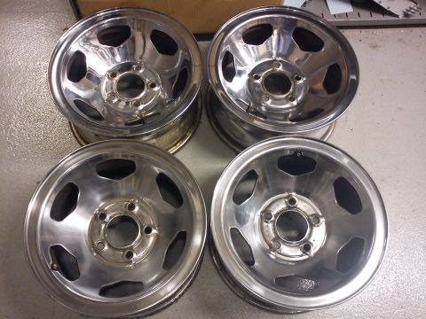 1997 Chevrolet Silverado 1500 - A set of four chrome wheels are displayed, likely for sale or as replacement parts.