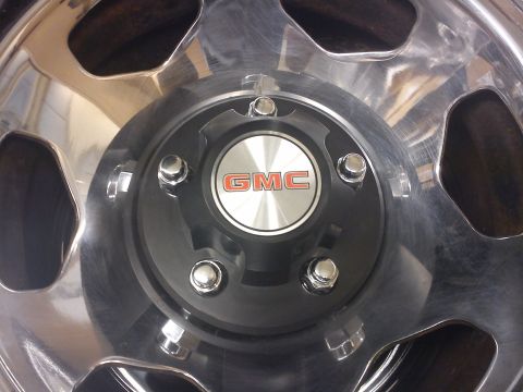 1997 Chevrolet Silverado 1500 - This image shows a close-up view of a GMC wheel, chrome spokes and a black center cap with the GMC logo.