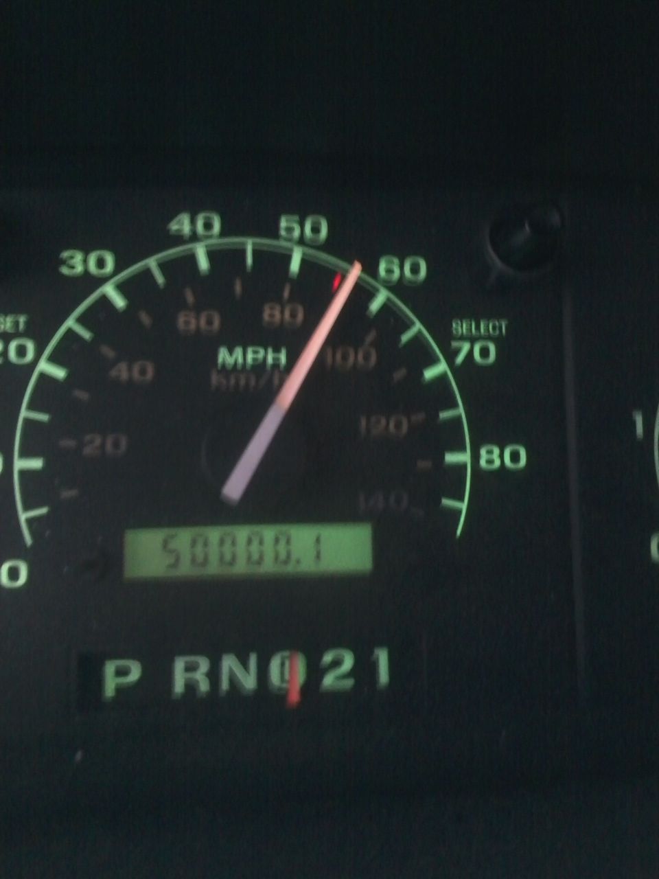 Vehicle dashboard with speedometer showing 55 MPH and odometer reading 50000.1 miles