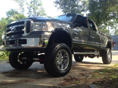 2006 Ford F-350 - This lifted Ford F-350 Super Duty pickup truck is shown from a three-quarter front angle.