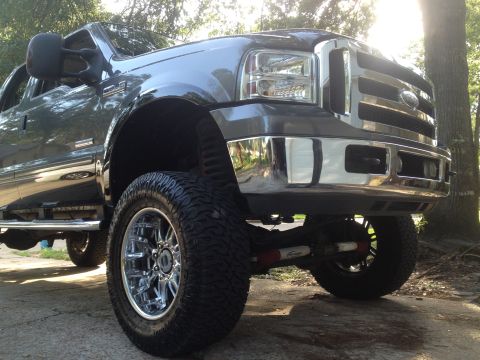 2006 Ford F-350 - Lifted Ford F-350 Super Duty truck with aftermarket chrome wheels and tires.