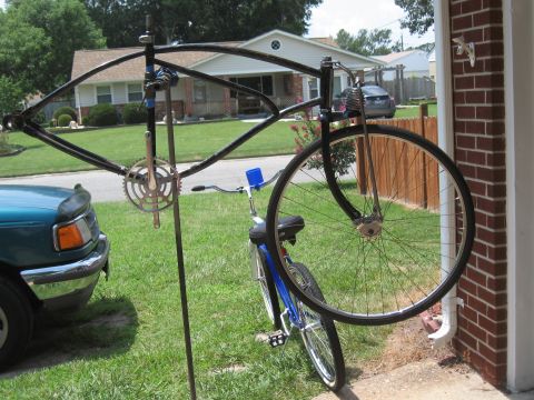 1994 Ford Bronco - A bicycle frame is mounted on a stand next to a blue cruiser bicycle.