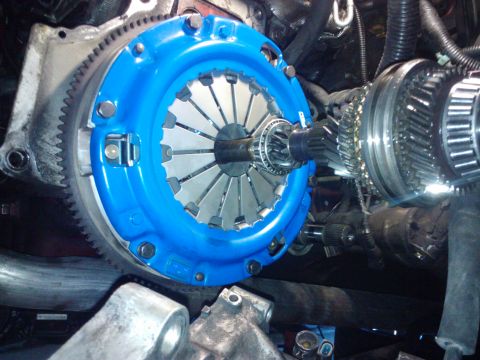 1995 Ford Probe - Clutch and transmission components are shown in detail, with a blue pressure plate and gears.