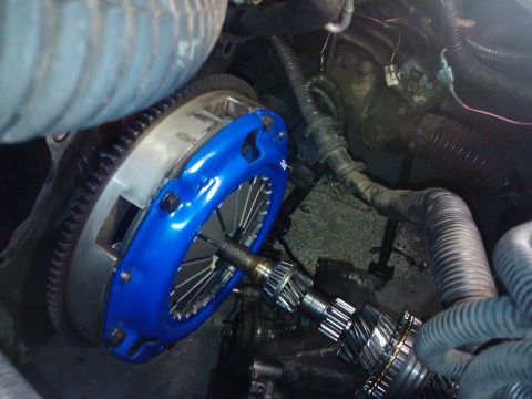 1995 Ford Probe - This image shows a close-up view of a vehicle's clutch and transmission components, with a bright blue pressure plate prominently featured.