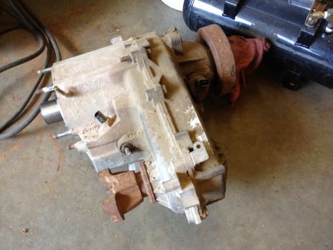 2000 Jeep Wrangler - Transfer case unit shown on a workshop floor, possibly for sale or repair.