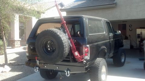 1995 Ford Bronco - Rear view of a black 1995 Ford Bronco equipped with a spare tire and Hi-Lift jack.
