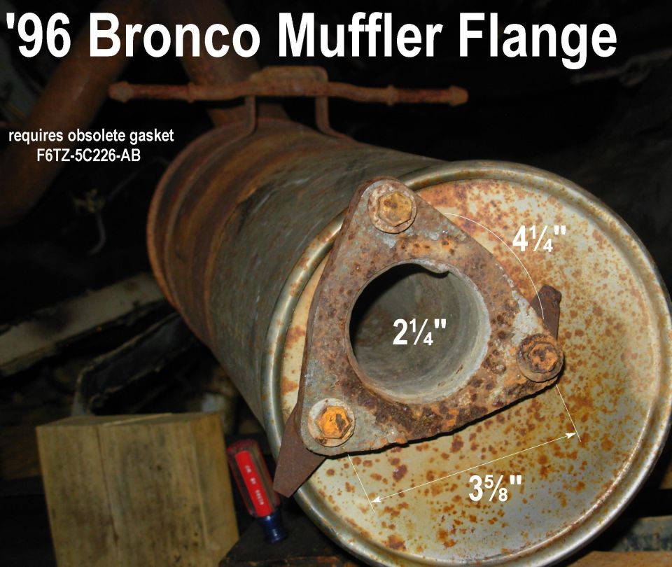 Rusty three-bolt muffler flange with 2¼" pipe opening and measurement labels