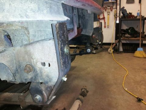 1995 Ford F-150 - Close-up of a truck's front bumper mounting hardware, showing rust and bolts.