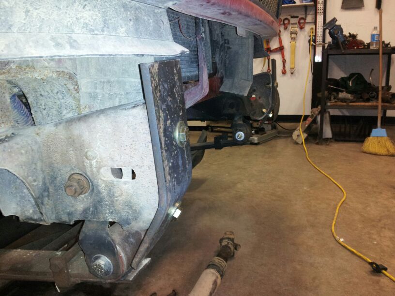 Truck front bumper mounting bracket and frame section, rusty metal, bolts visible