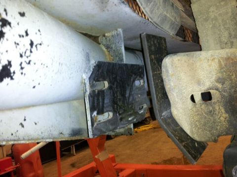 1995 Ford F-150 - A close-up view of a custom bumper bracket attached to a vehicle's frame, showing metal fabrication details.
