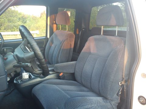 1997 Chevrolet Silverado 1500 - The interior of a truck shows the driver and passenger seats, steering wheel, and dashboard area.