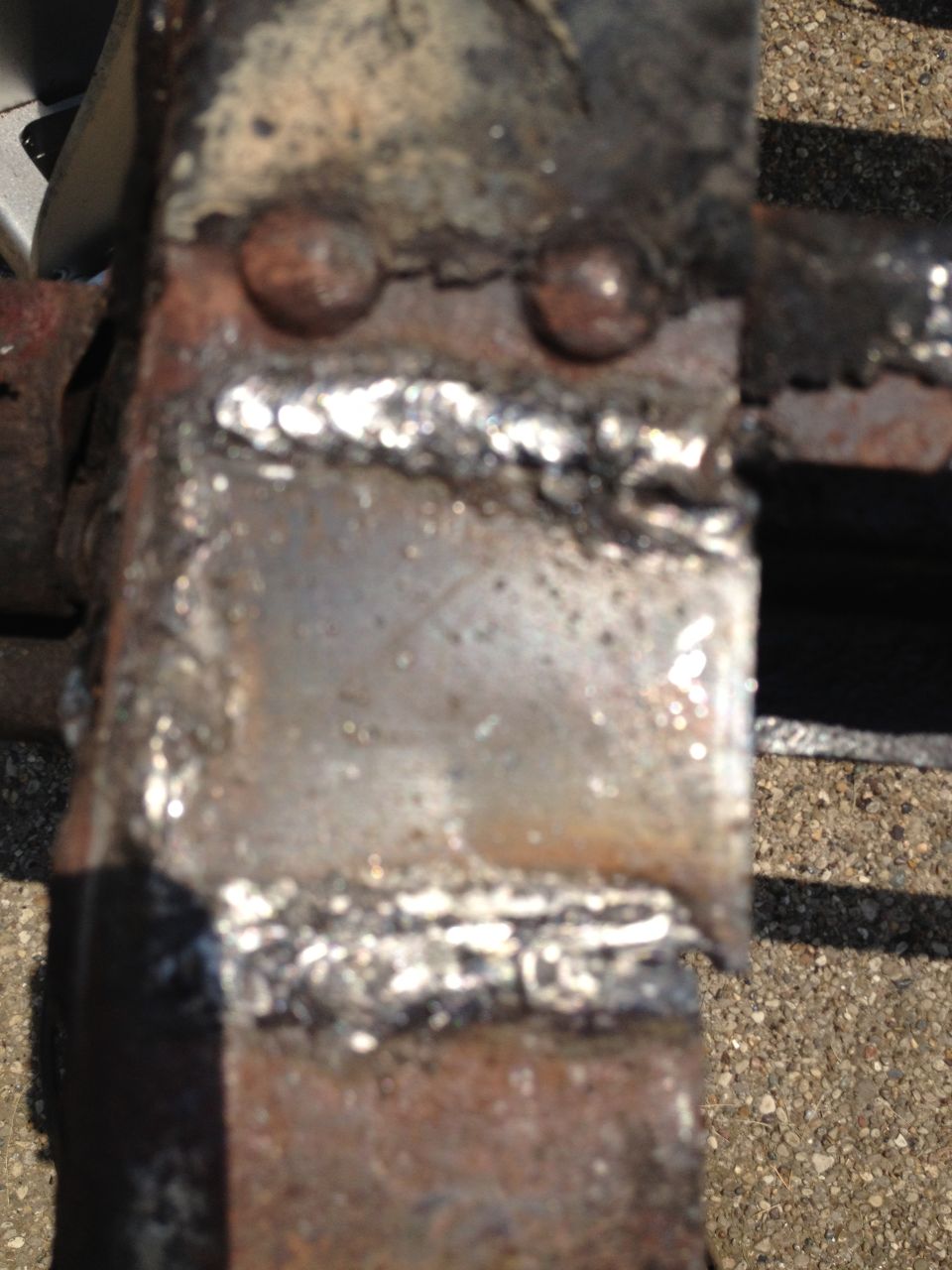 Close-up of welded metal frame with rivets