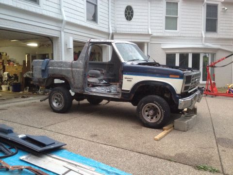 1986 Ford Bronco - This Ford Bronco appears to be undergoing restoration, with significant bodywork and interior components removed.