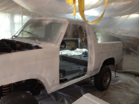 1986 Ford Bronco - This Ford Bronco is being prepped for paint, with its interior removed and the body covered in primer.