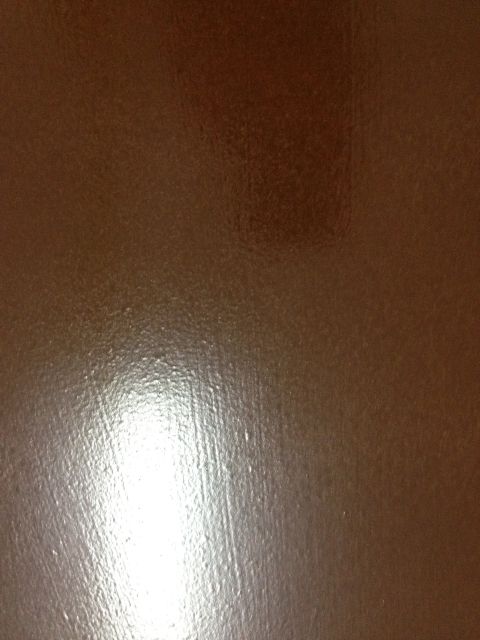 1986 Ford Bronco - Close-up of a brown textured surface with a watermark at the bottom right.
