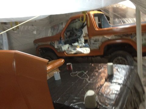 1986 Ford Bronco - This 1986 Ford Bronco is being prepped for a new paint job, with its doors open and interior masked.