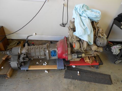 1986 Jeep Wagoneer - Engine and transmission assembly, likely for a Jeep, is shown disassembled and mounted on a dolly.