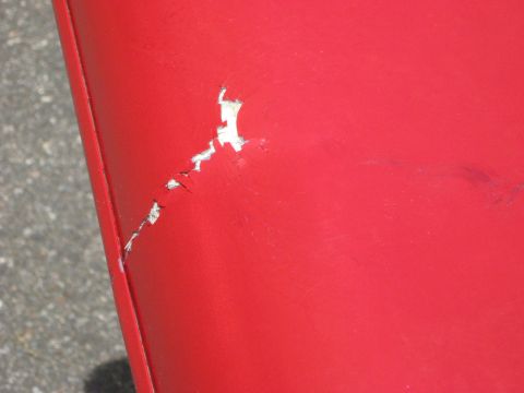 2001 Ford F-150 - Close-up of a damaged red surface with a watermark at the bottom right.