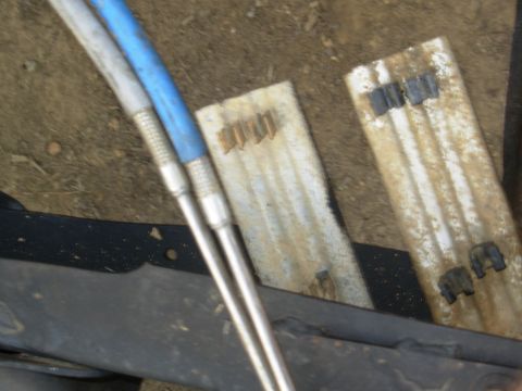 1983 Ford Bronco - The '93 frame-to-engine fuel line guide (under the driver's feet) uses riveted spring steel clips. The '95 uses snap-in plastic clips.