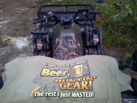 1986 Ford Bronco - An all-terrain vehicle is parked outdoors, partially obscured by a t-shirt with a humorous slogan.